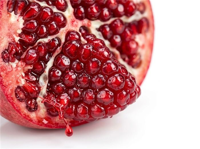 Fresh red pomegranate arils that flavor the Hinuki jelly stick